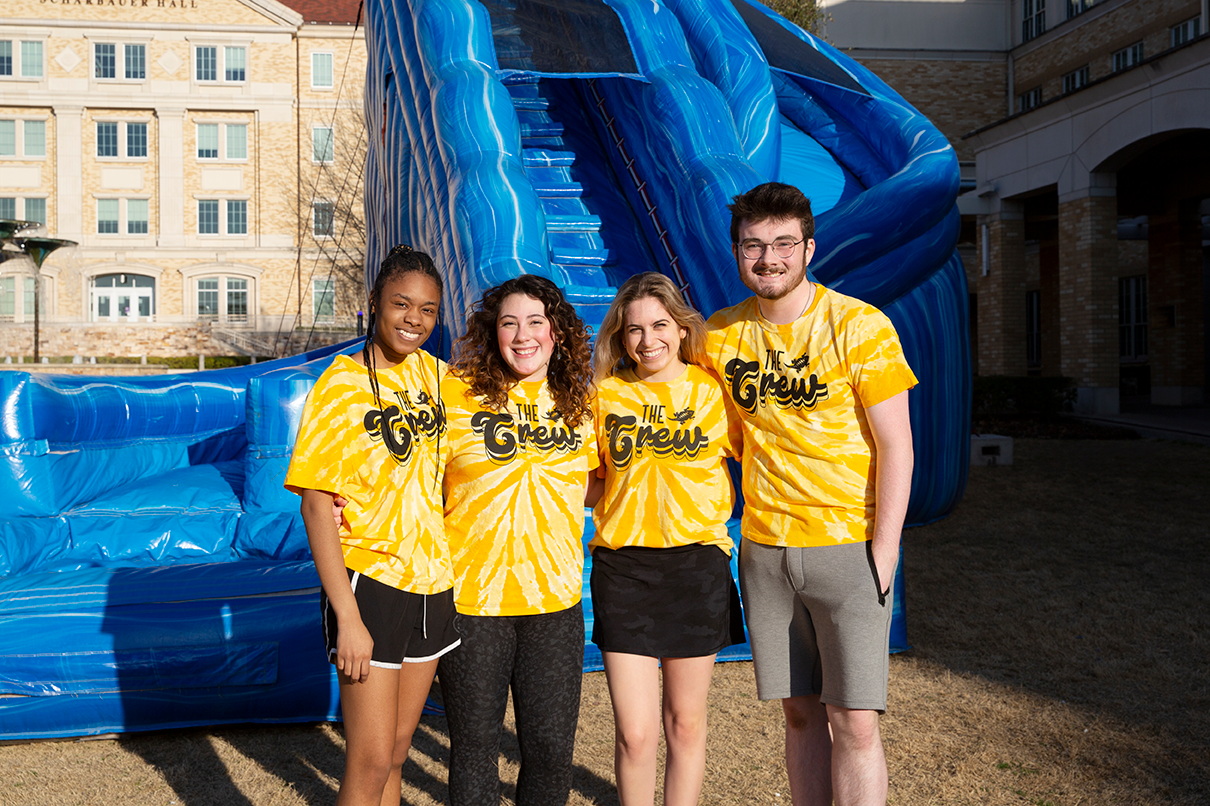 Four TCU Students in yellow The Crew Shirts