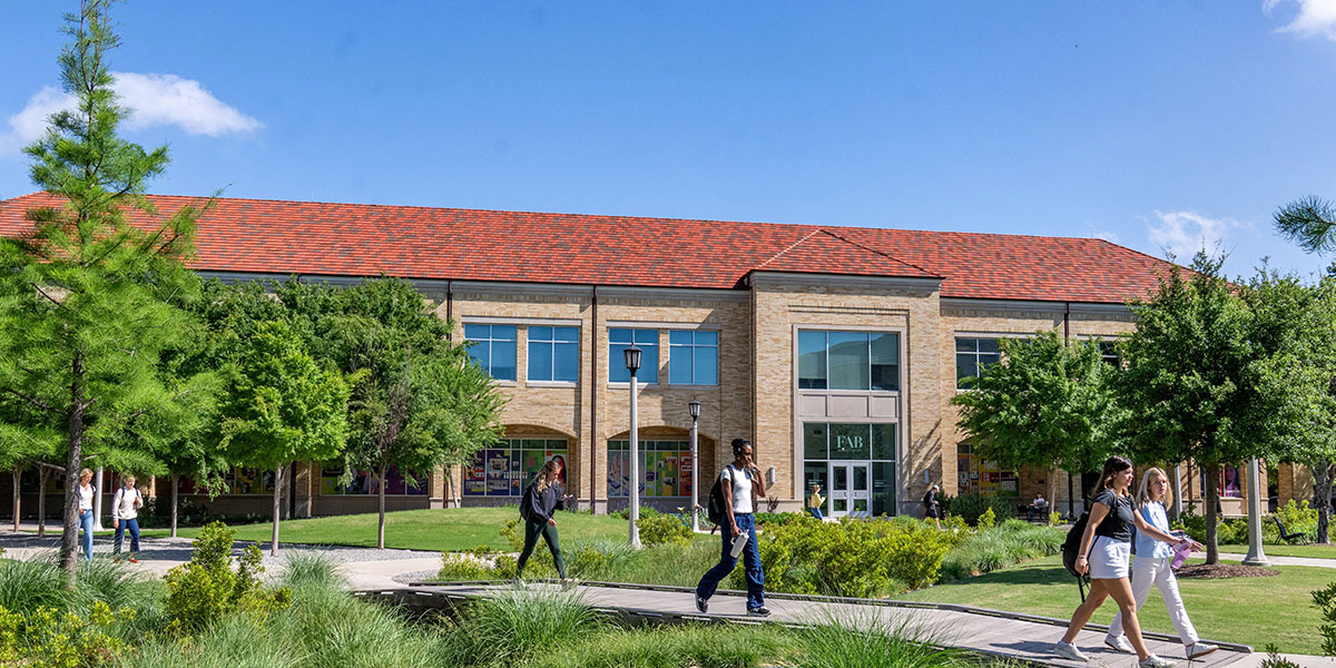 TCU students walking near the Fine Arts Building