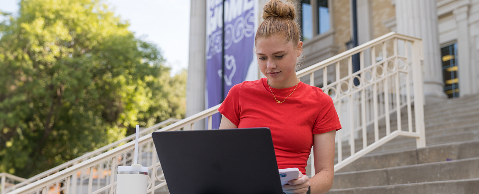 TCU student working on laptop