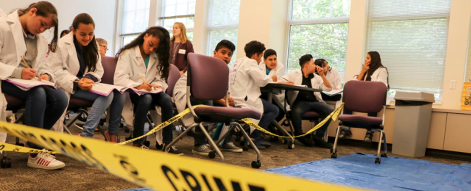 Andrews Institute Summer Camp Students learning to assess prints, blood type, and pen ink 