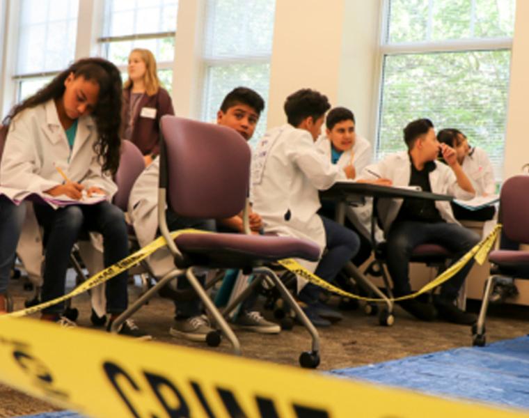 Andrews Institute Summer Camp Students learning to assess prints, blood type, and pen ink 