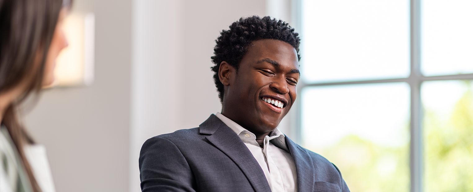 Smiling student speaking with a TCU representative