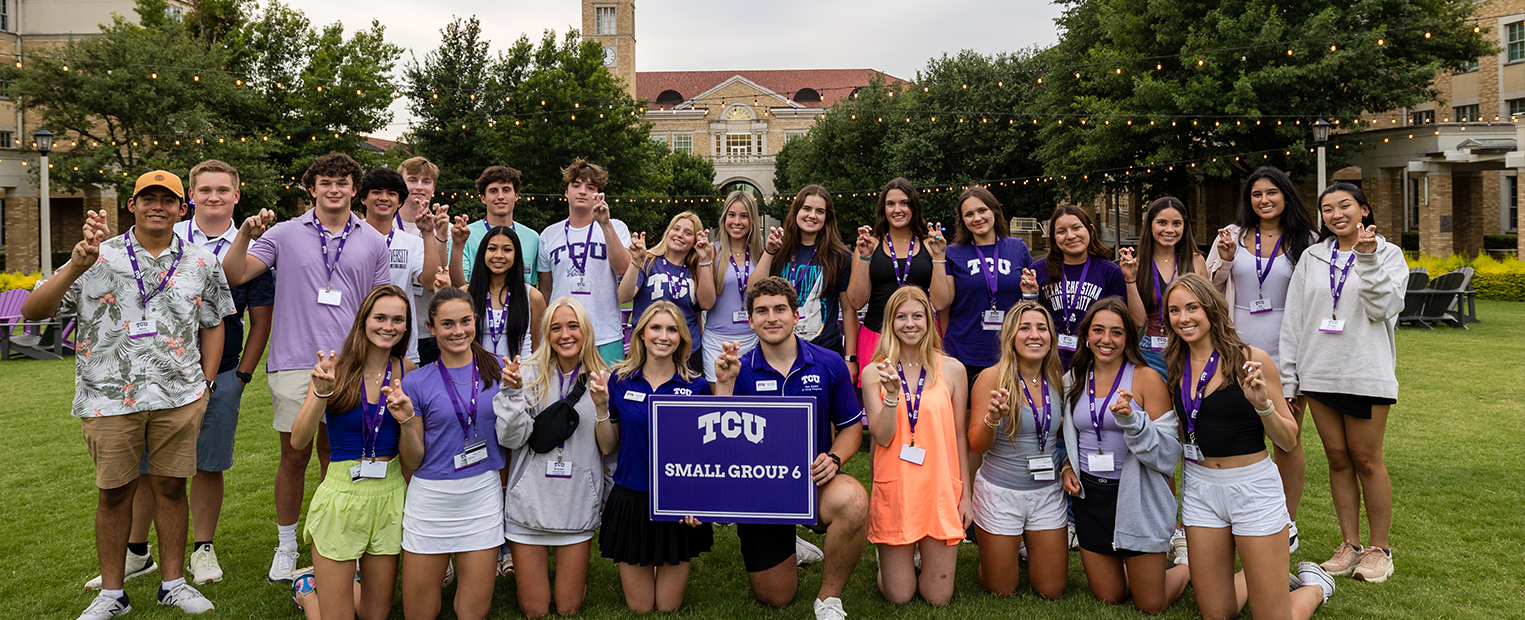 TCU students in small group four posing for a picture at the commons for Orientation 