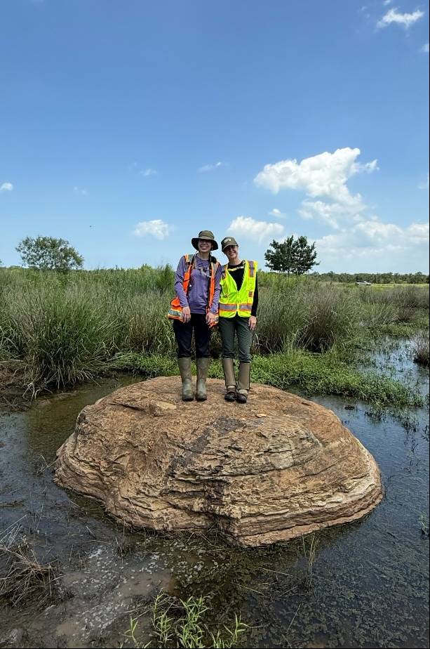 Solomon and her coworker on a rock formation in Taylor, Texas.