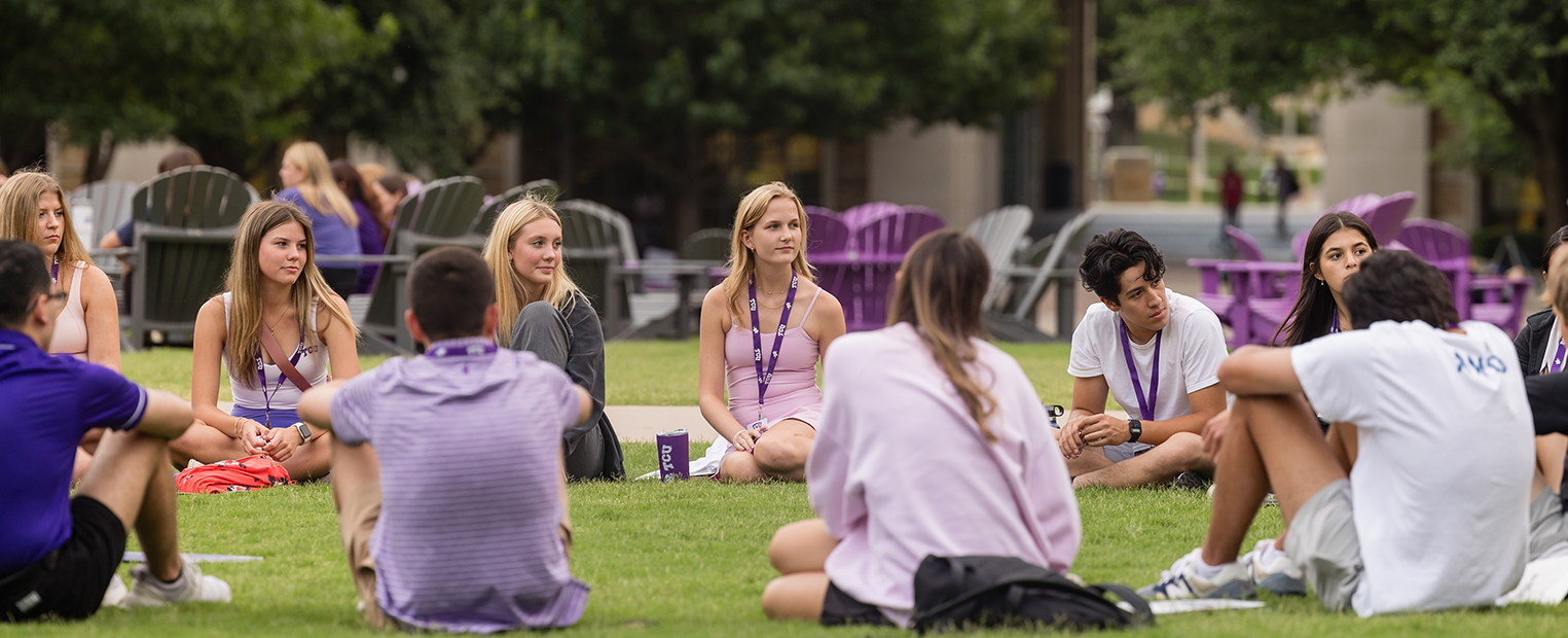 TCU students sitting in a circle at the commons 