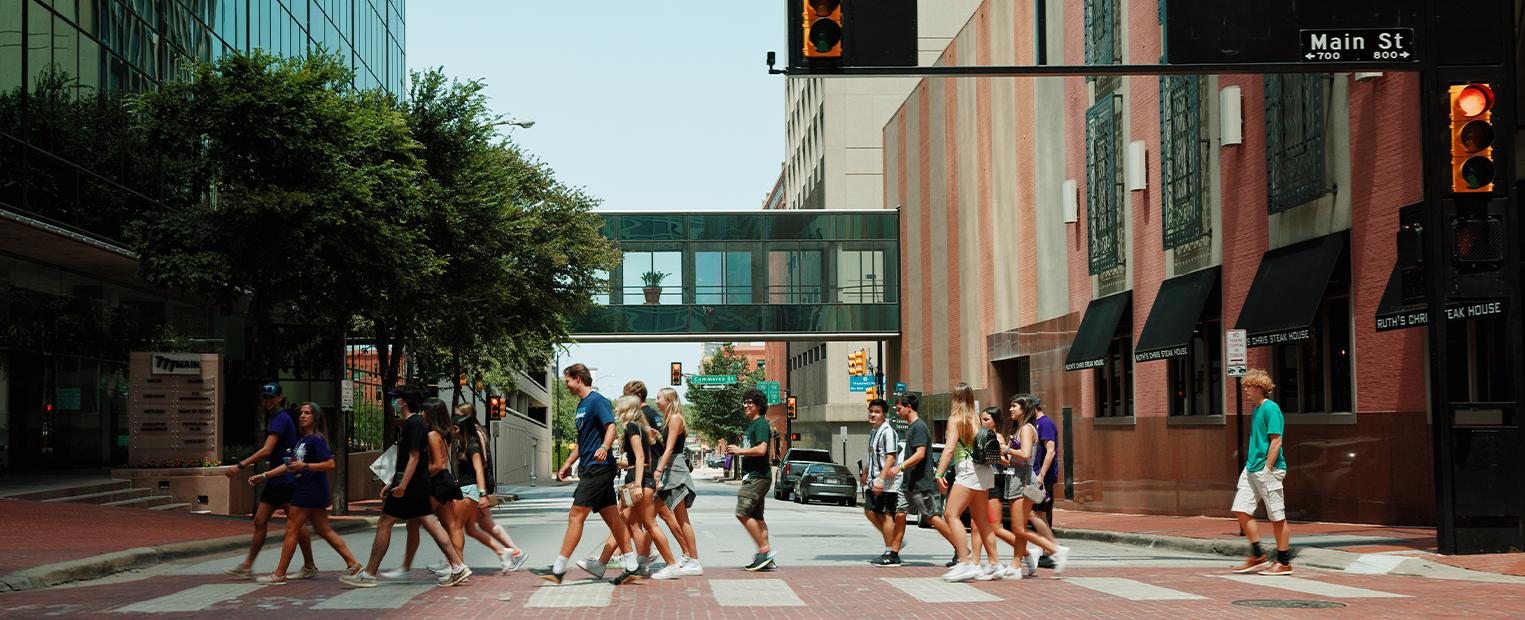 frog camp group walking in a crosswalk downtown