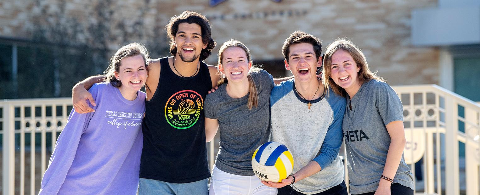 students playing sand volleyball 