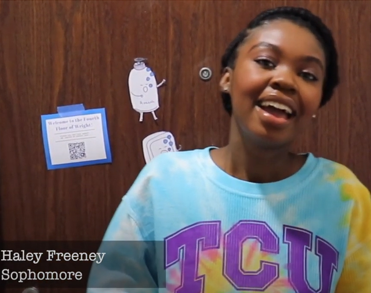 Haley Freeney in front of her dorm room door