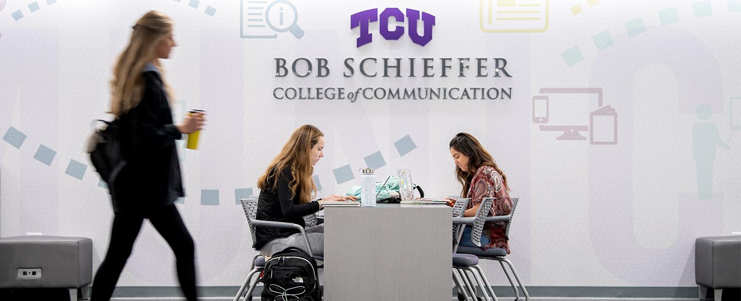 students working in the lobby of the communication building 