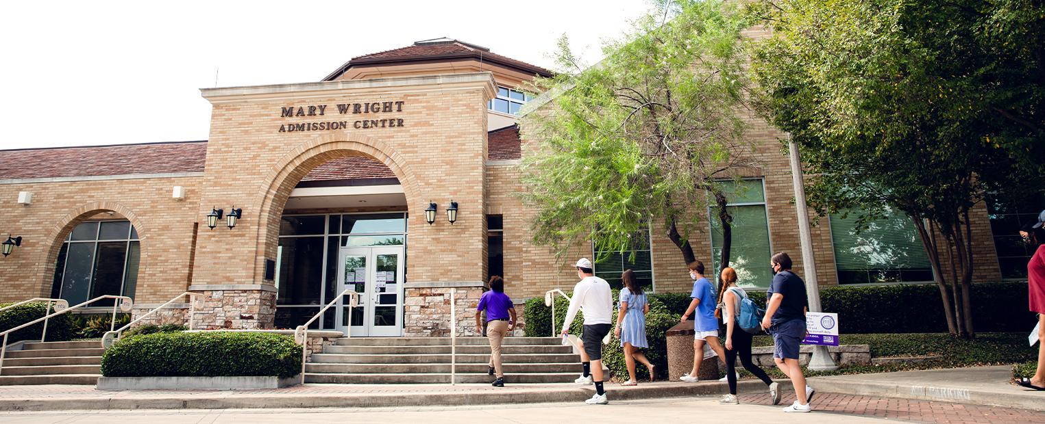 students from a tour entering the admission center 