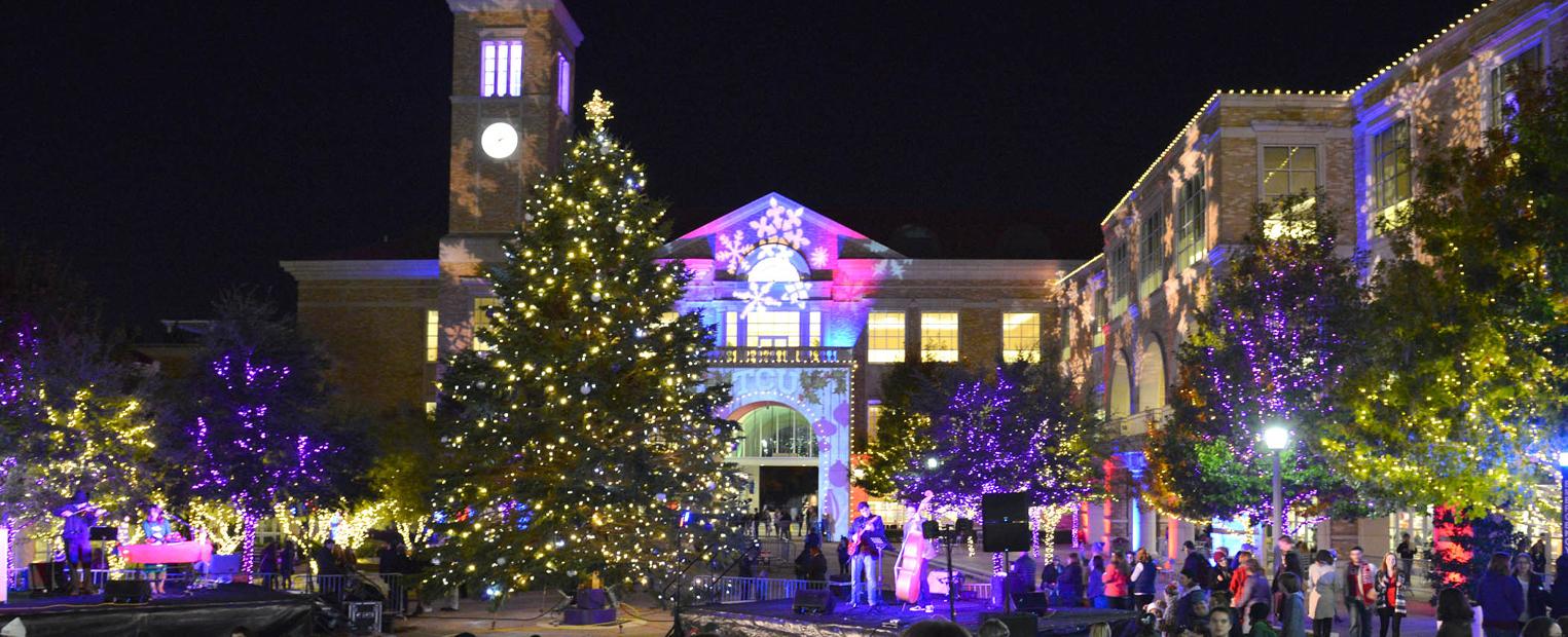 TCU Christmas Tree lit up in front of the BLUU archway 