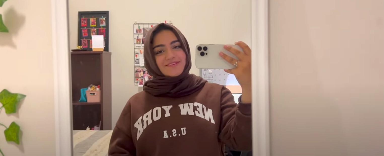 female student taking a selfie in her dorm 